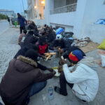 Refugees and asylum seekers gather during sit-in outside the UNHCR headquarters, in Tunis