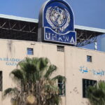 Palestinians gather to inspect the damages at the headquarters of UNRWA in Gaza City